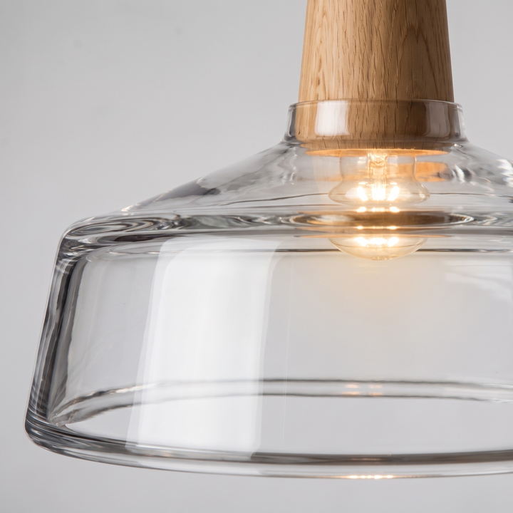 Two clear glass oak pendant lights above kitchen island in Scandinavian kitchen