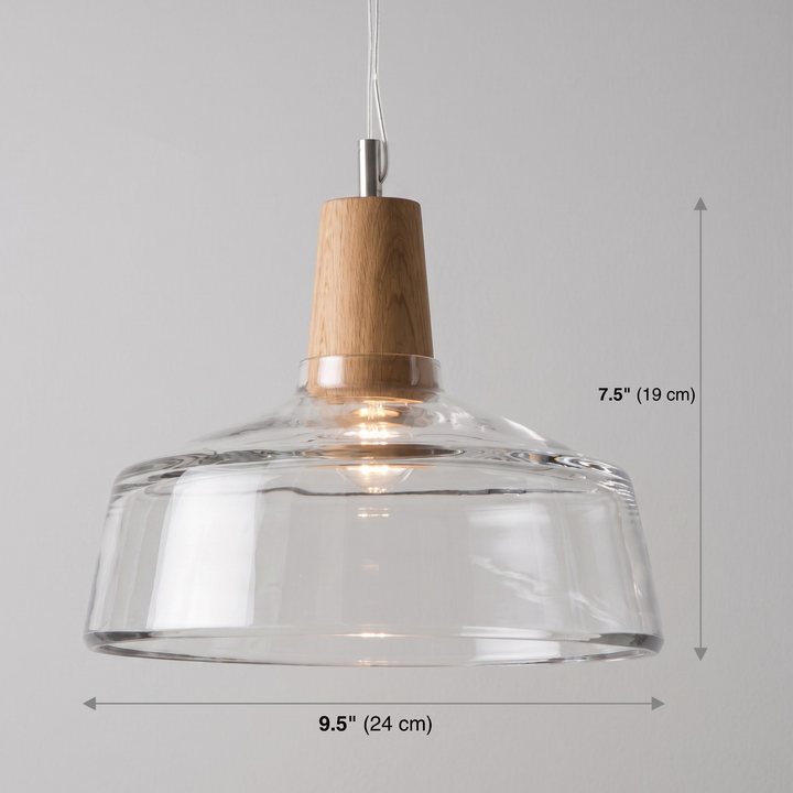 Clear glass pendant light with dimension lines on grey wall