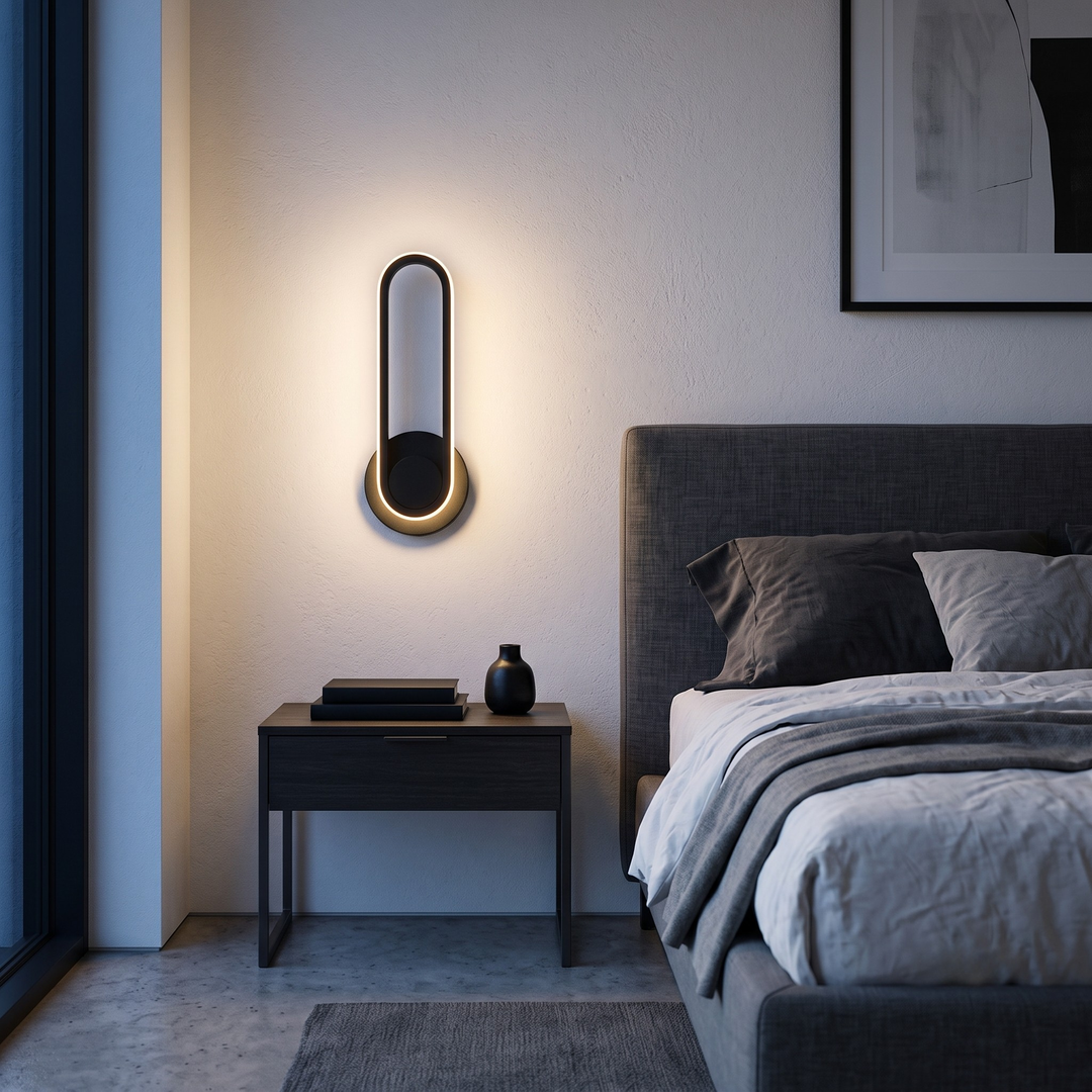 Black oval ring wall sconce mounted beside bed in modern bedroom