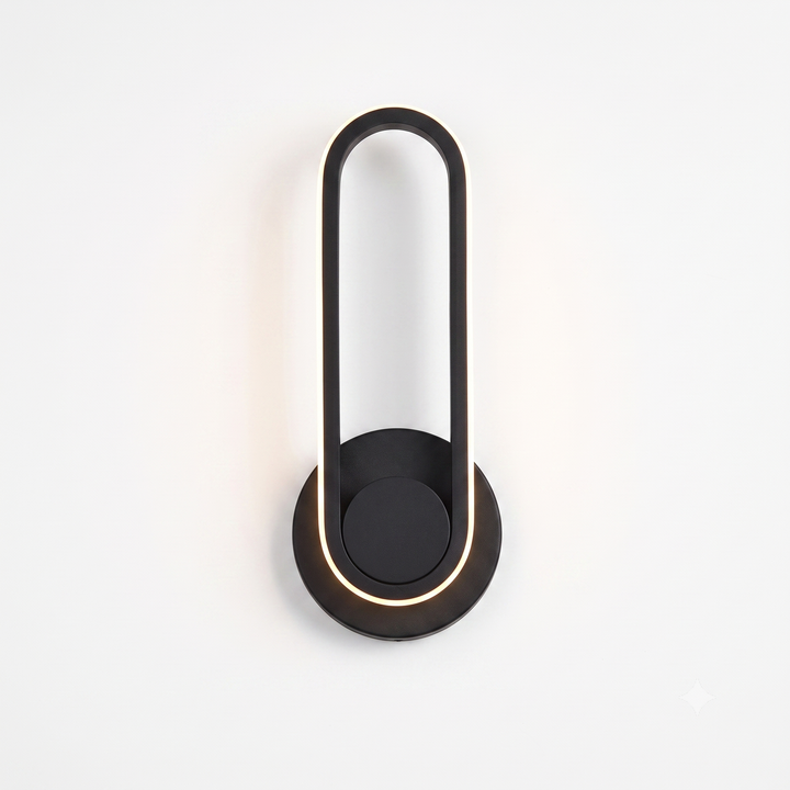 Black oval LED wall sconce with warm white glow on white background