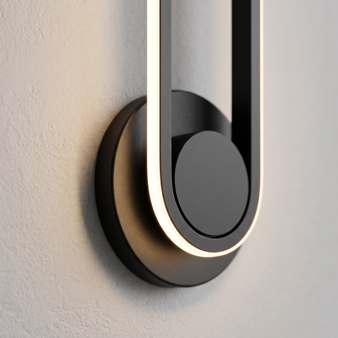 Close-up of black oval LED wall sconce with glowing inner edge